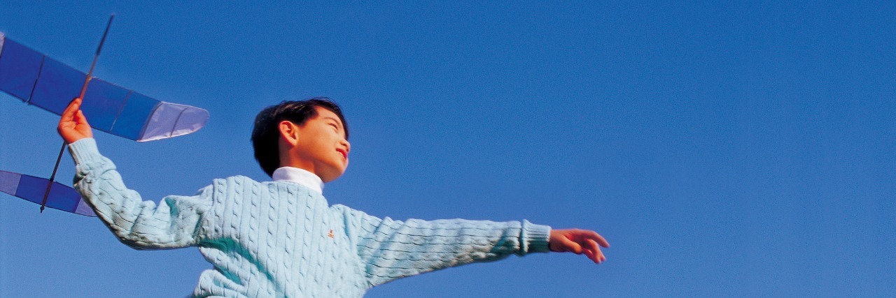 Autism: When My Son Asked Me What Was Wrong With Him boy playing with toy plane against sky background