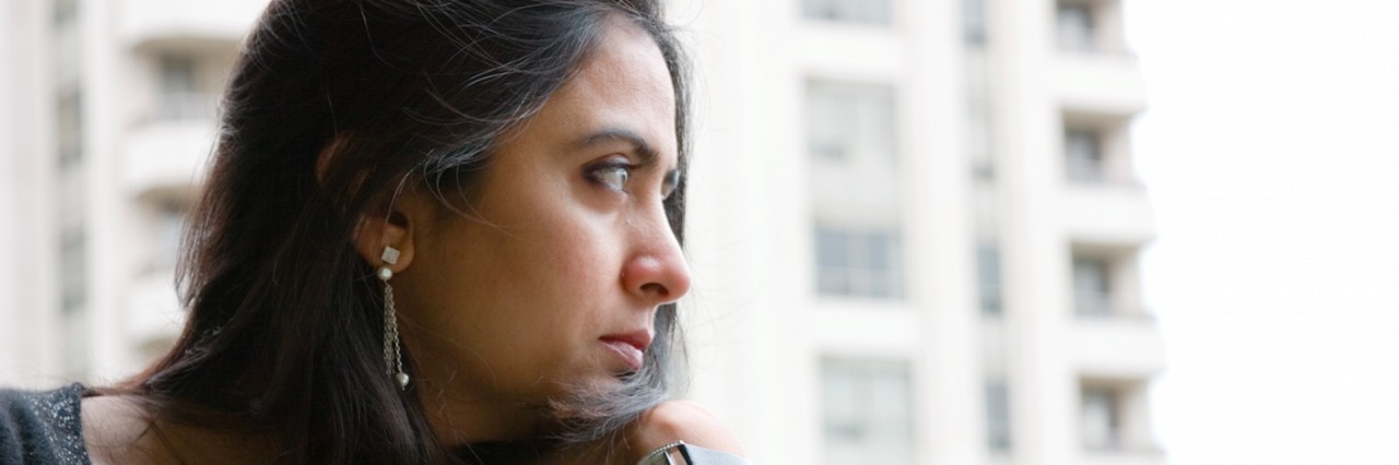 Woman looking pensive while looking out of the window