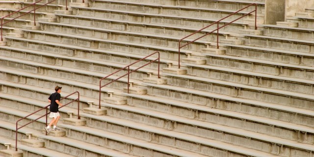 8 Things I Hide as a Collegiate Athlete With Mental Illness college athlete running up empty bleachers