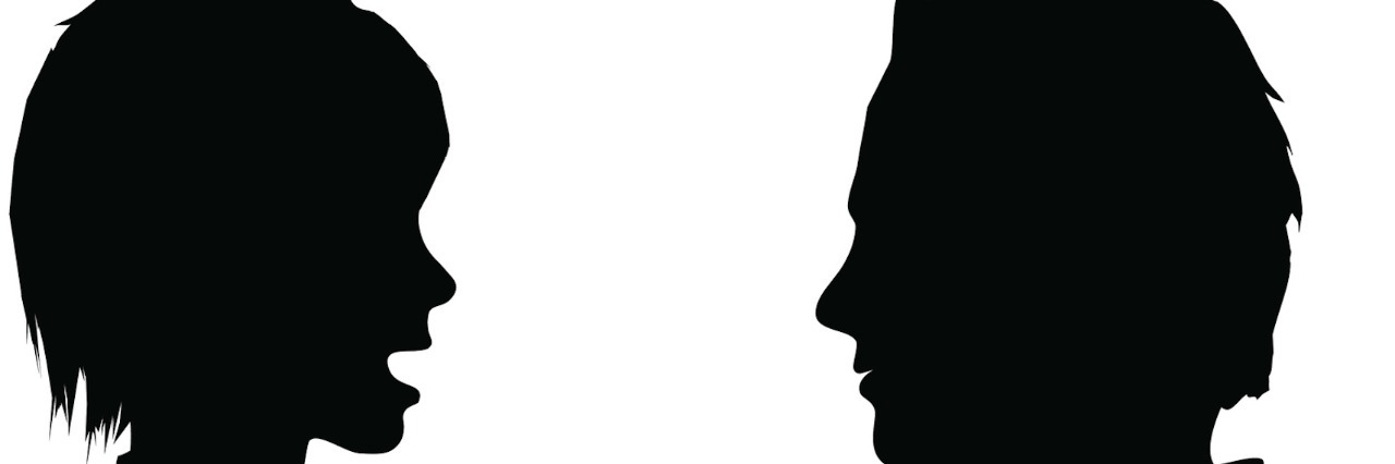 Silhouette of woman talking to man