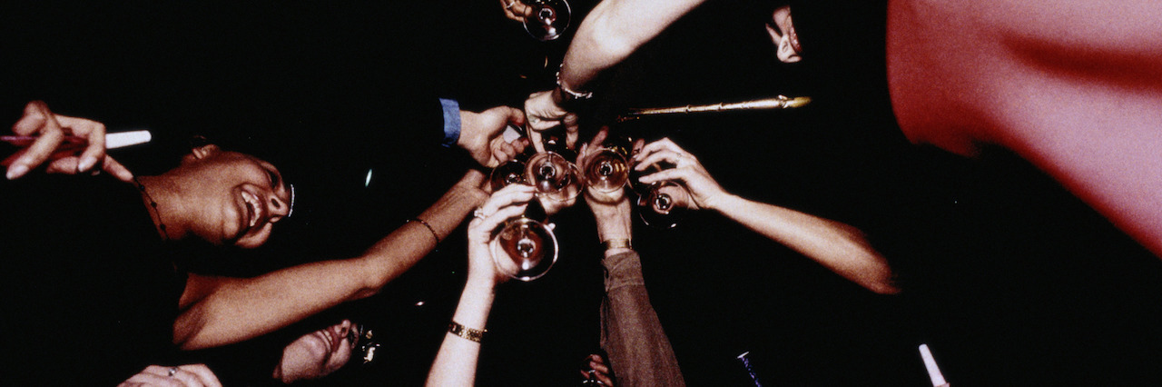 The Struggles of a Person With Anxiety on New Year's Eve a group of friend's making a toast
