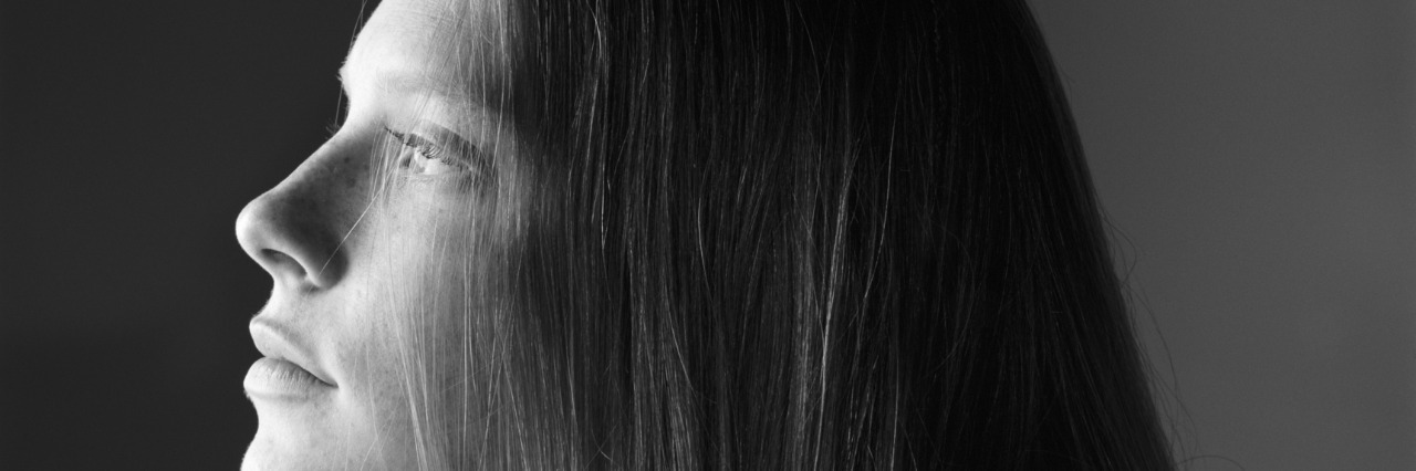 The Danger in Comparing Eating Disorder Recovery Stories a teenage girl with long hair sits pensively