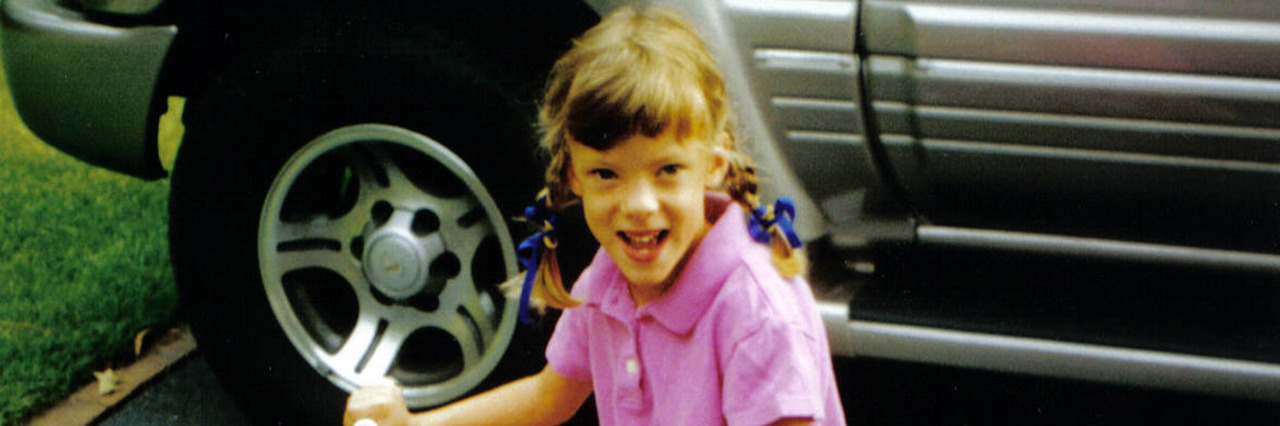 Talking to My Younger Self Growing Up With Cerebral Palsy Amelia riding her bike.