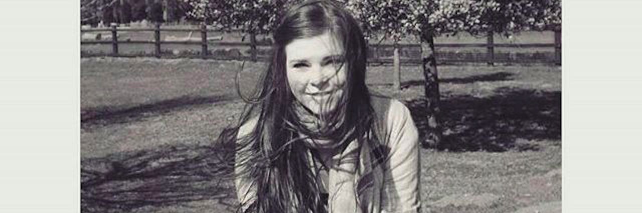 5 Stages of Chronic Illness No One Tells You About girl sitting on a statue at a park