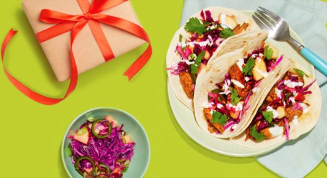 hello fresh meal of tacos on table next to wrapped gift
