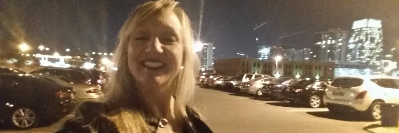woman taking a selfie outside in the city at night