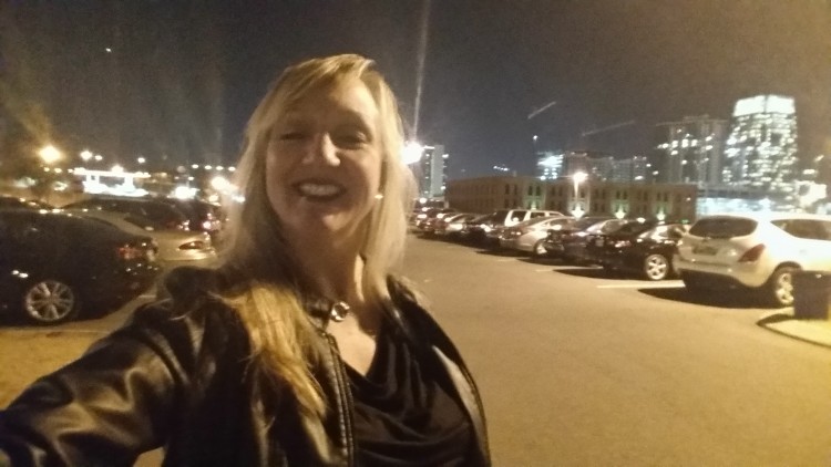 woman taking a selfie outside in the city at night