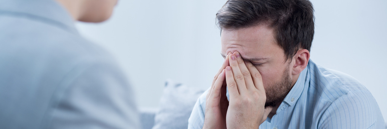 Man with depression crying during psychotherapy session