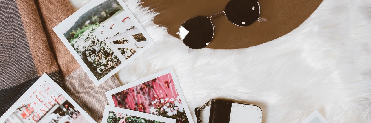 How Photo Projects Can Help You Through Postpartum Depression Hat with photos on bed