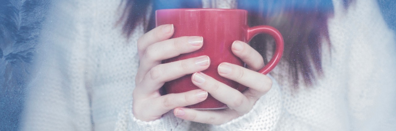 A Letter to Those Who Are Sick and Dreading the Holidays woman wearing white sweater and holding red coffee mug