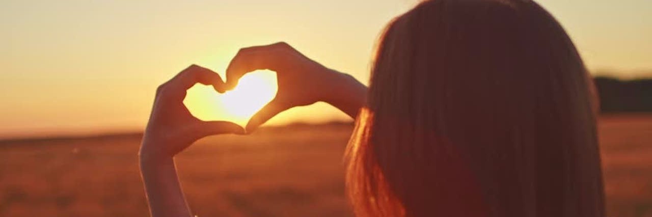 To the Friends Who Stayed Through My Eating Disorder young woman making heart with her hands
