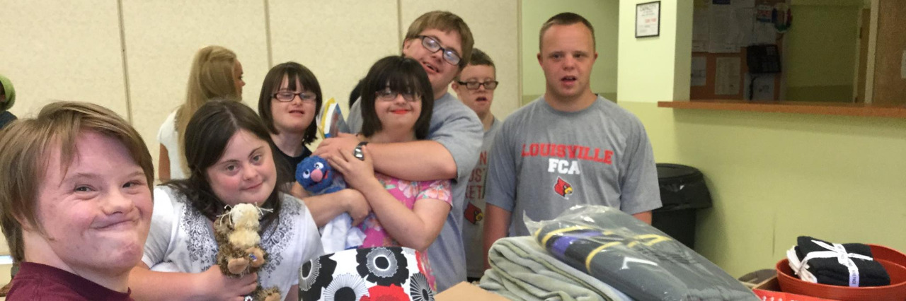 Students with Down syndrome packing refugee welcome boxes.