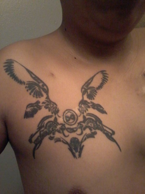 tattoo of wings on man's chest