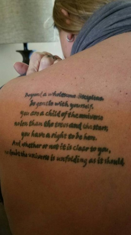tattoo of writing on back of shoulder