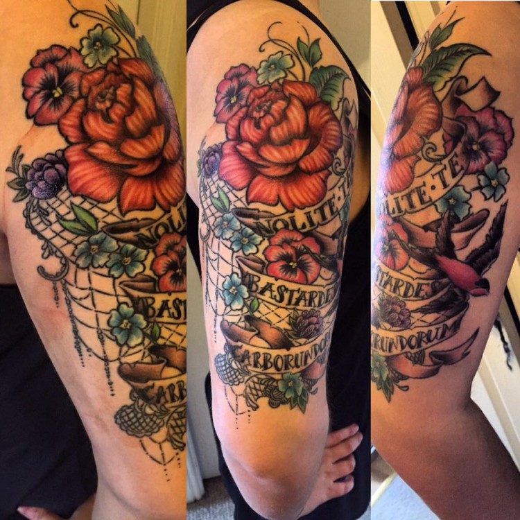 large tattoo of roses and vines on upper arm