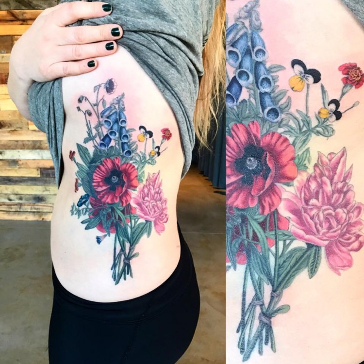 colorful tattoo of flowers on side of woman's body