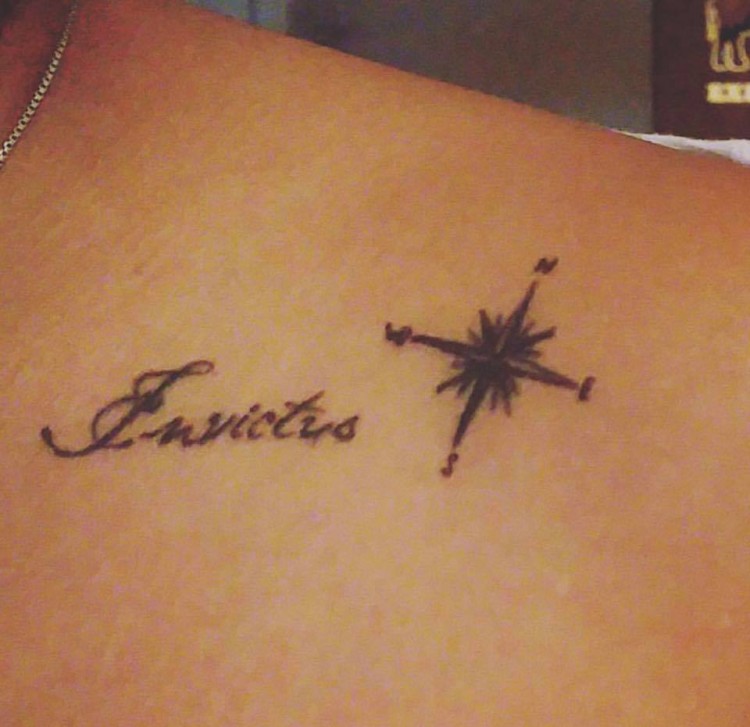 tattoo on back of shoulder that says invictus and image of compass