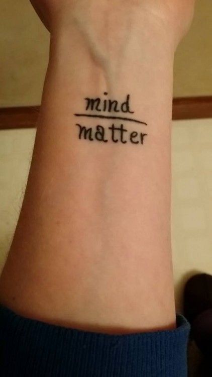 tattoo of words mind and matter with a line between them