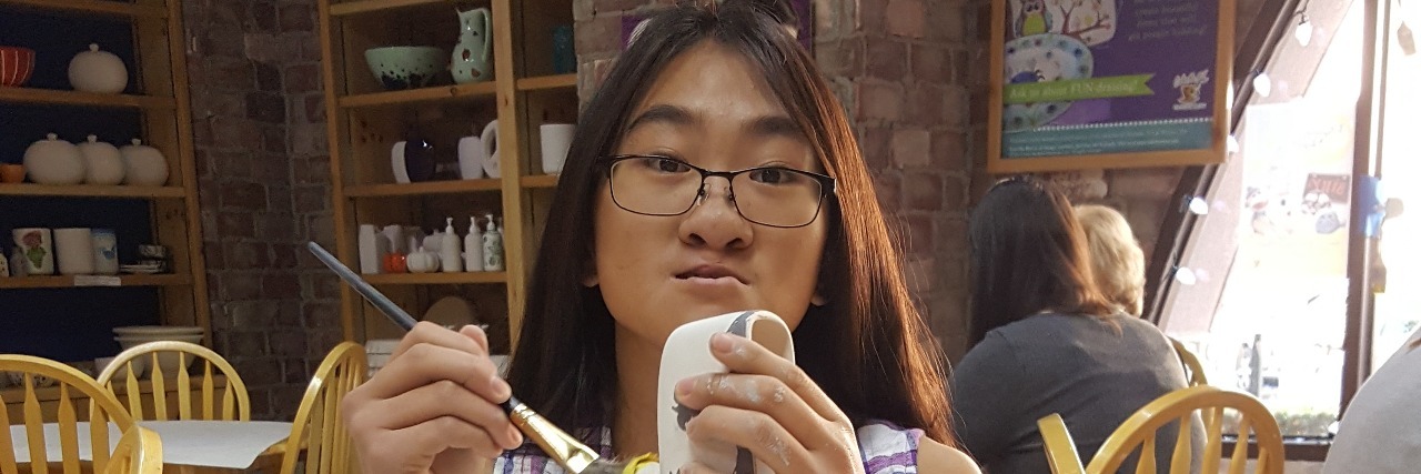 How I Prioritize My Good Day To-Do List with Lupus girl sitting at table painting pottery