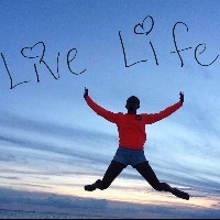person jumping in air with sky in background and words live life on sky