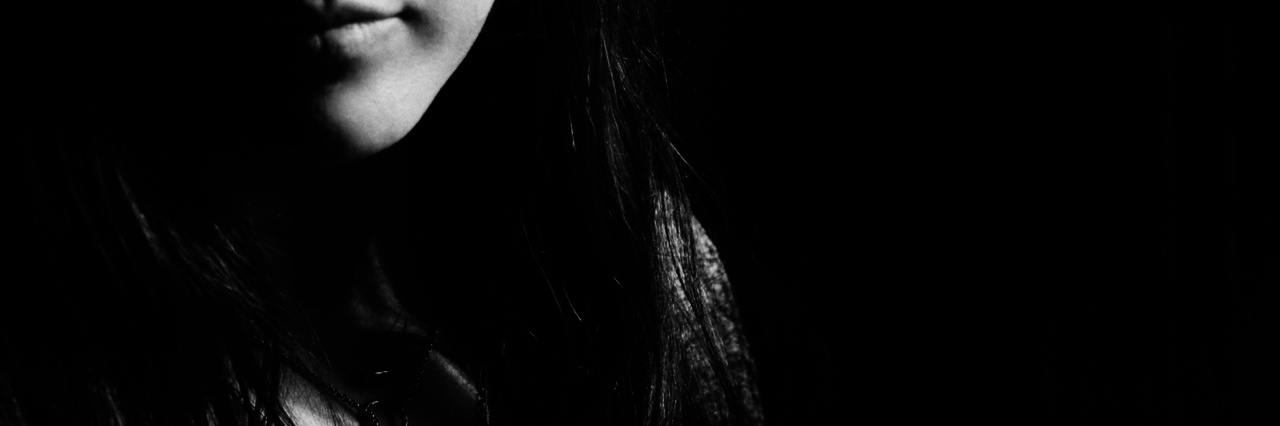 5 Things I Ask Myself Every Day to Help Manage My Bipolar Disorder picture of half a woman's face, black and white, slight smile