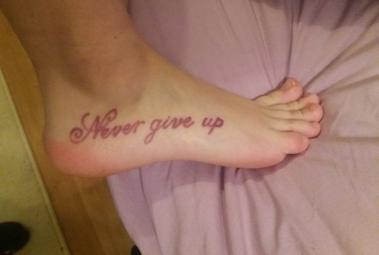 A tattoo that says, "Never give up."