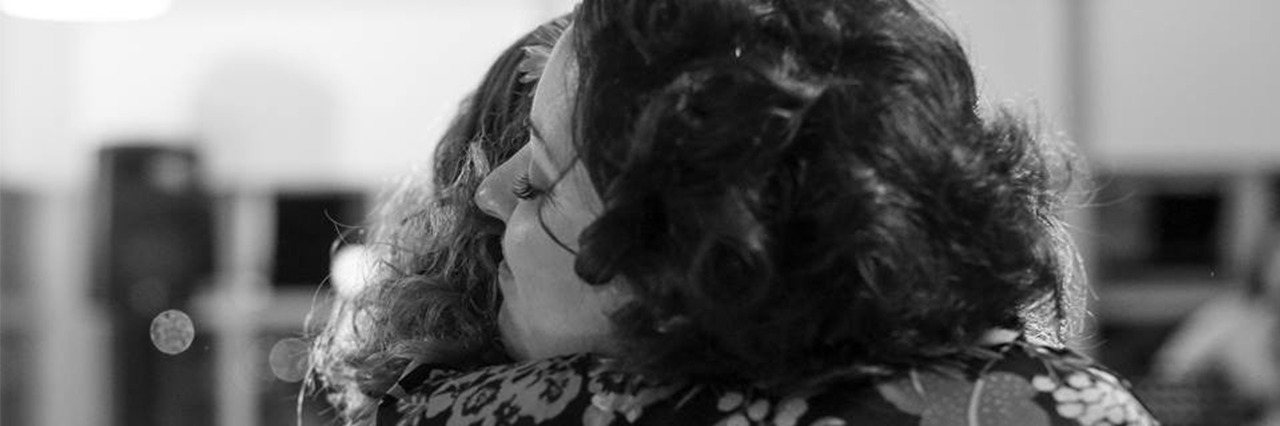 4 Ways to Help Somebody Struggling With Mental Illness two women hugging at a wedding