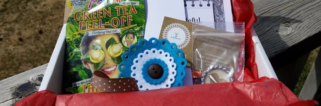 Taylor Nadraszky Creates Be Brave Box, a Subscription Box for Chronic Illness Sample Be Brave box featuring a coloring book and face mask.