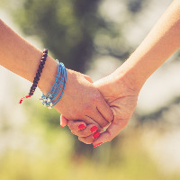 Two female friends holding hands