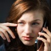 A worried looking woman on the phone