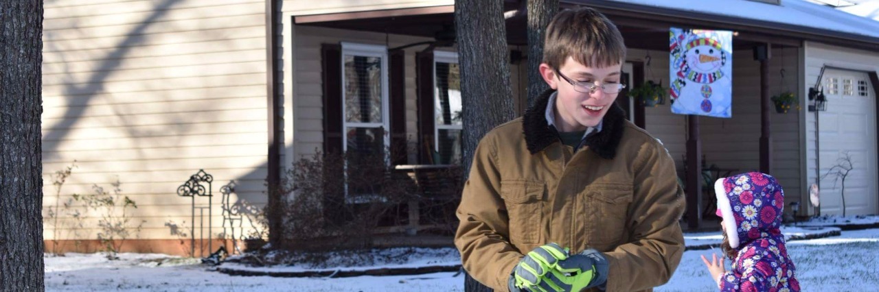 To Parents Asking 'Should I Let My Kid Play With an Autistic Child?' a young man standing in a snowy street