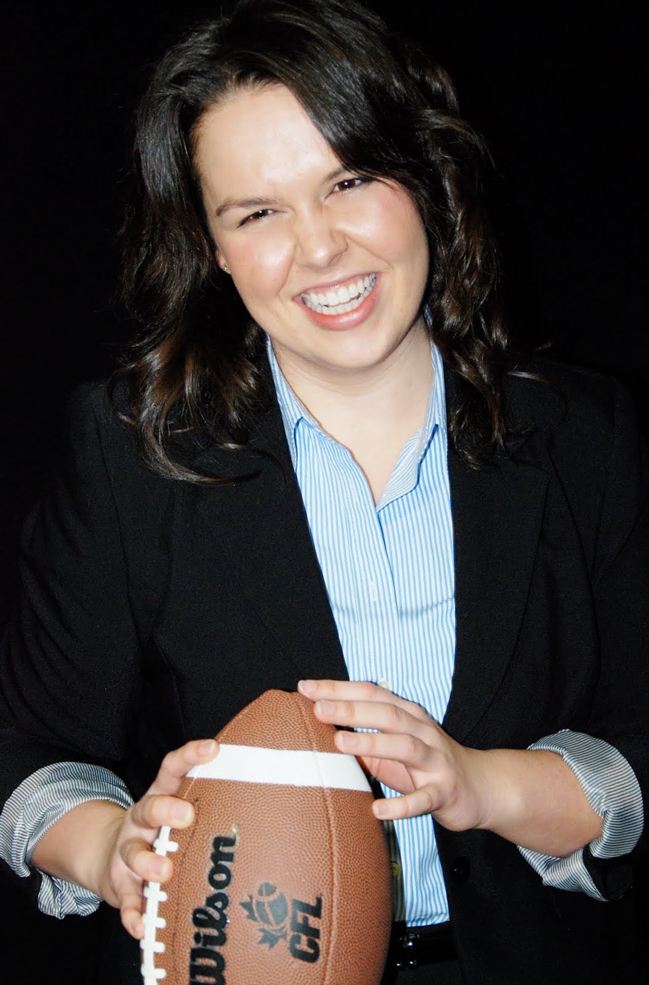 woman smiling with a football