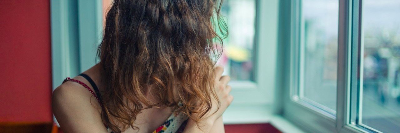 It’s Hard to Make New Friends When You’re Chronically Ill woman in restaurant looking out window