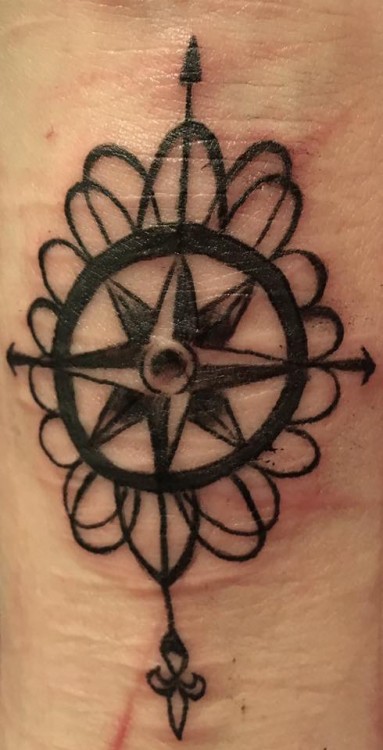 A tattoo of a compass