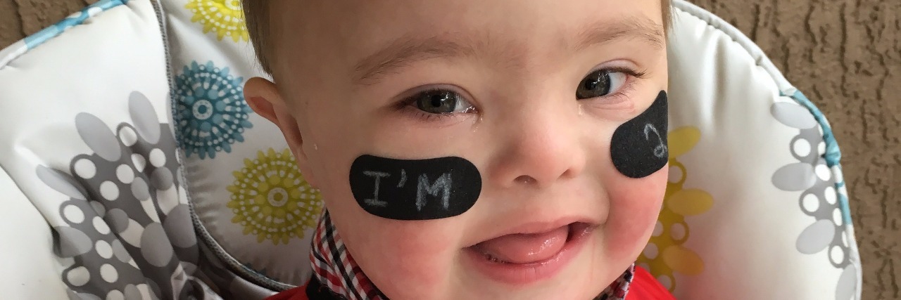 A Letter to My Son With Down Syndrome on His 2nd Birthday baby with down syndrome in football jersey