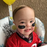 baby with down syndrome in football jersey