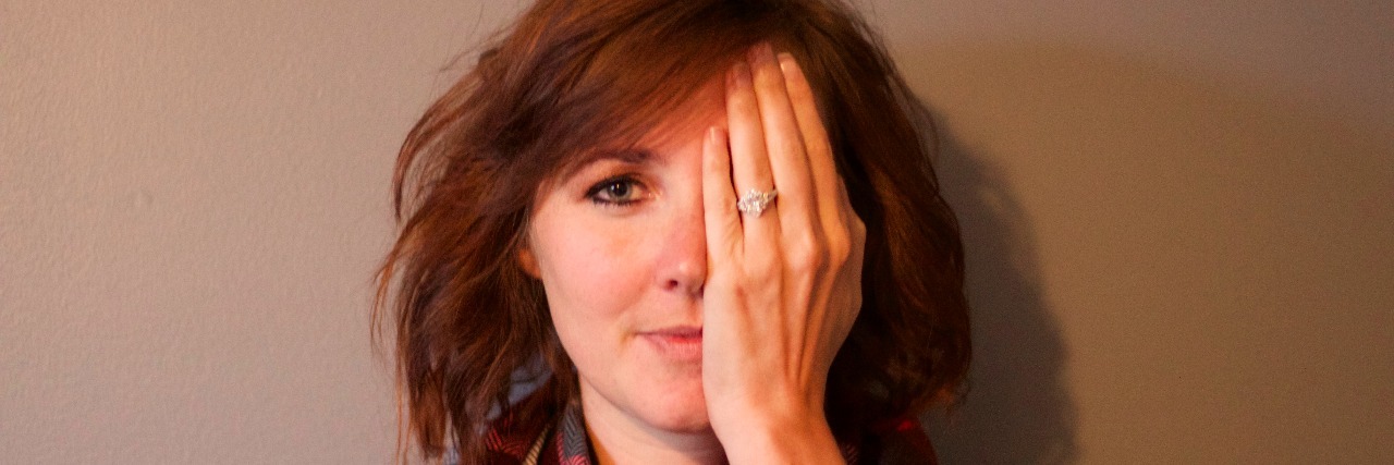 What It Was Like Showering at the Hospital woman covering her eye with her hand