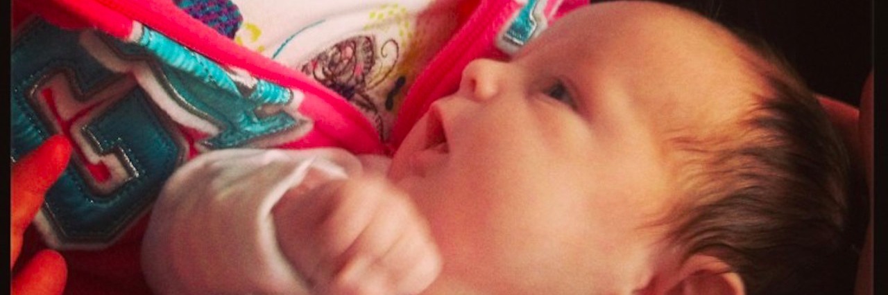 Pregnancy After Child Loss young girl holding baby sister in her arms