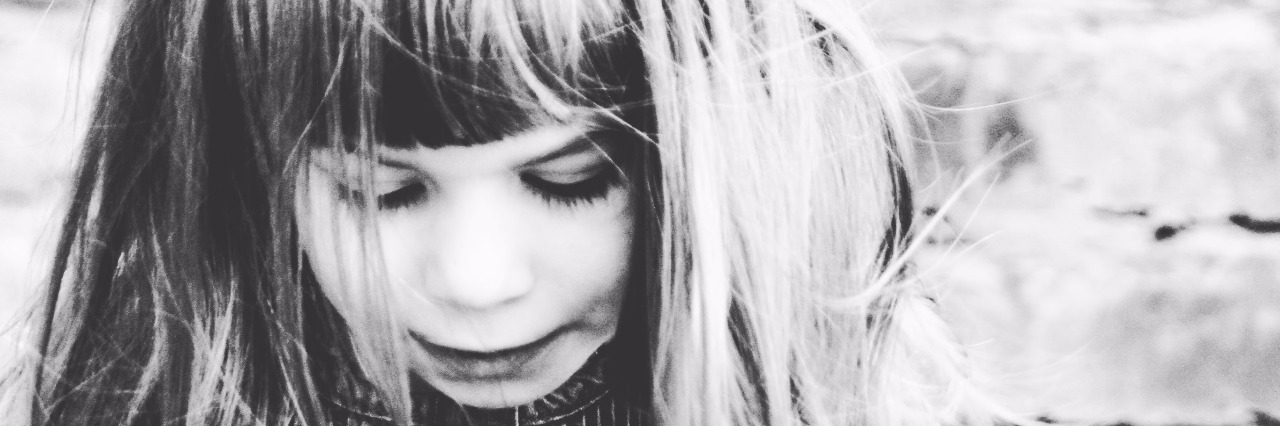 Things I Wish I Knew the Day of My Child's Autism Diagnosis Black and white photo of child in front of brick wall