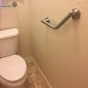 bathroom with grab bar on wall