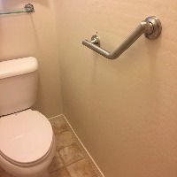 bathroom with grab bar on wall