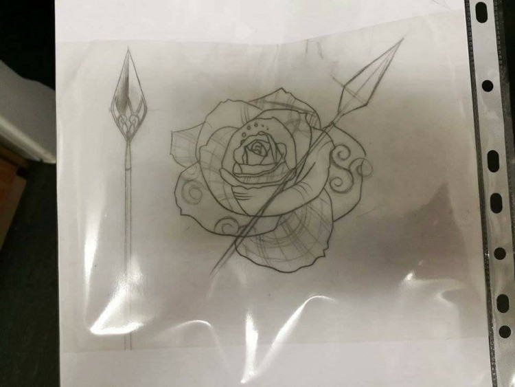 A sketch of a tattoo design with a flower