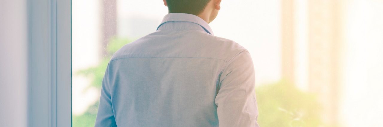 Having a Genetic Condition and the Impact on Family Planning man drinking hot coffee by window