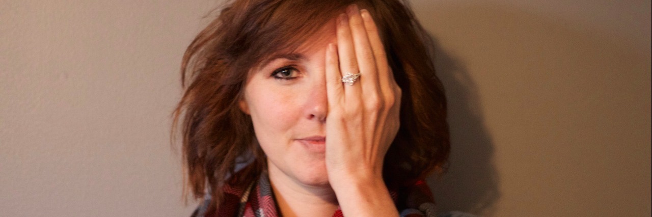 Facing Judgment at Work Because of My Disability woman putting hand over one eye