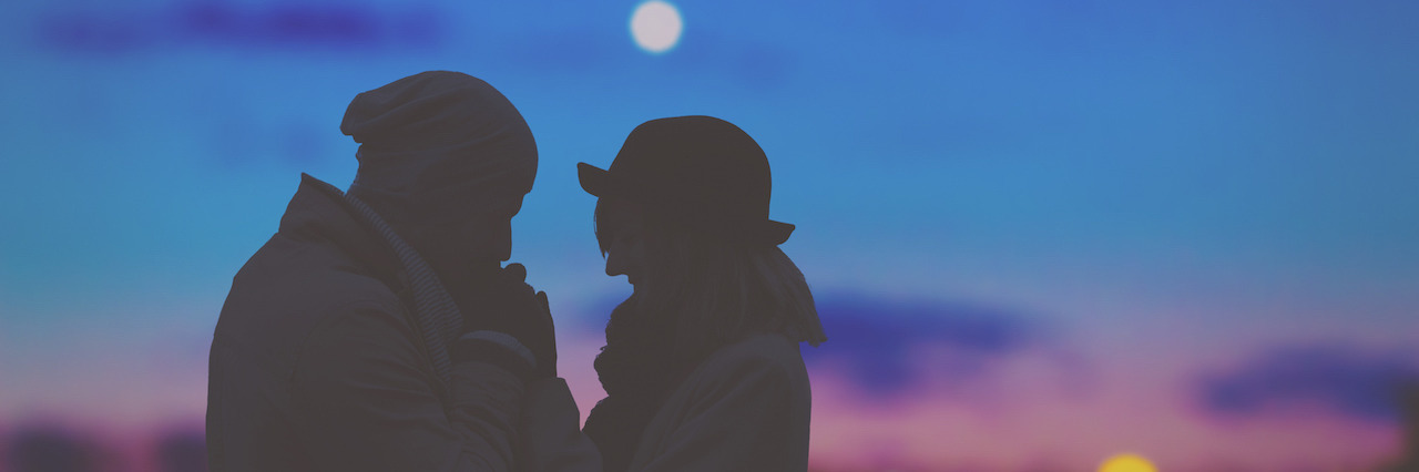 3 Ways to Love Someone With Depression and Anxiety A couple standing outside in front of a sunset.