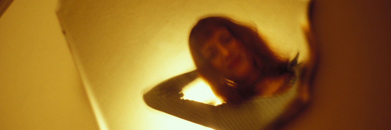 When You Hide Your Anxiety and Depression A woman's reflection in a mirror