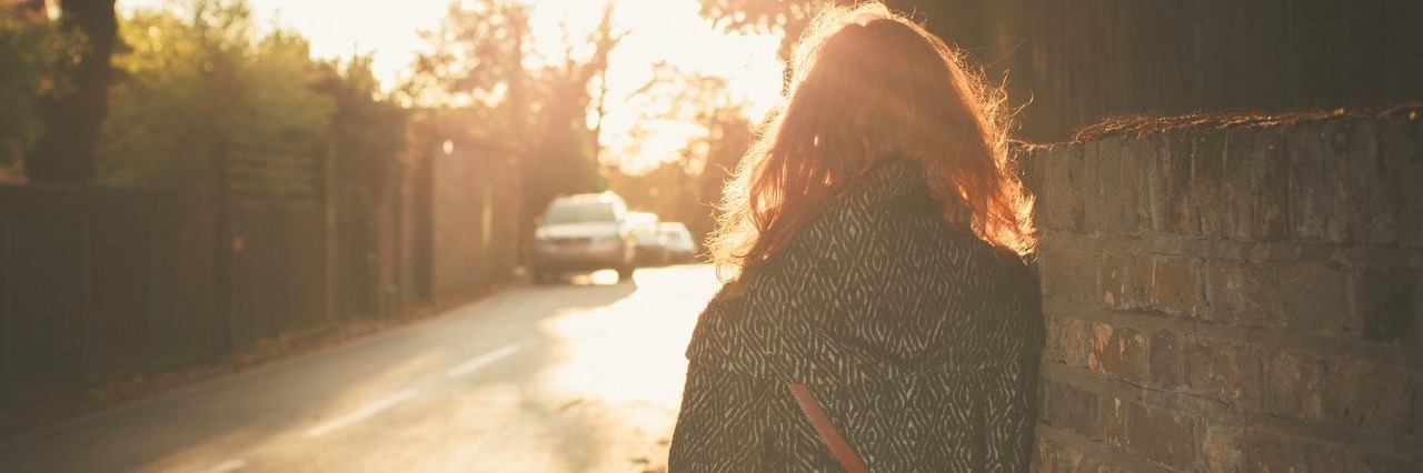 Letter to the Person Who Told Me Fibromyalgia Doesn’t Exist young woman walking into sunset in the city