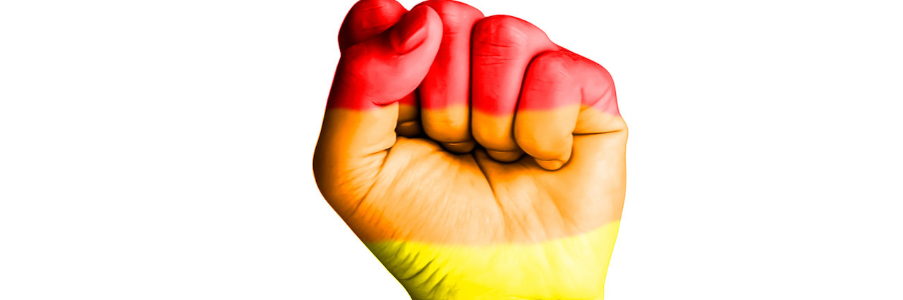 Fist hand with rainbow flag patterned isolate on white background