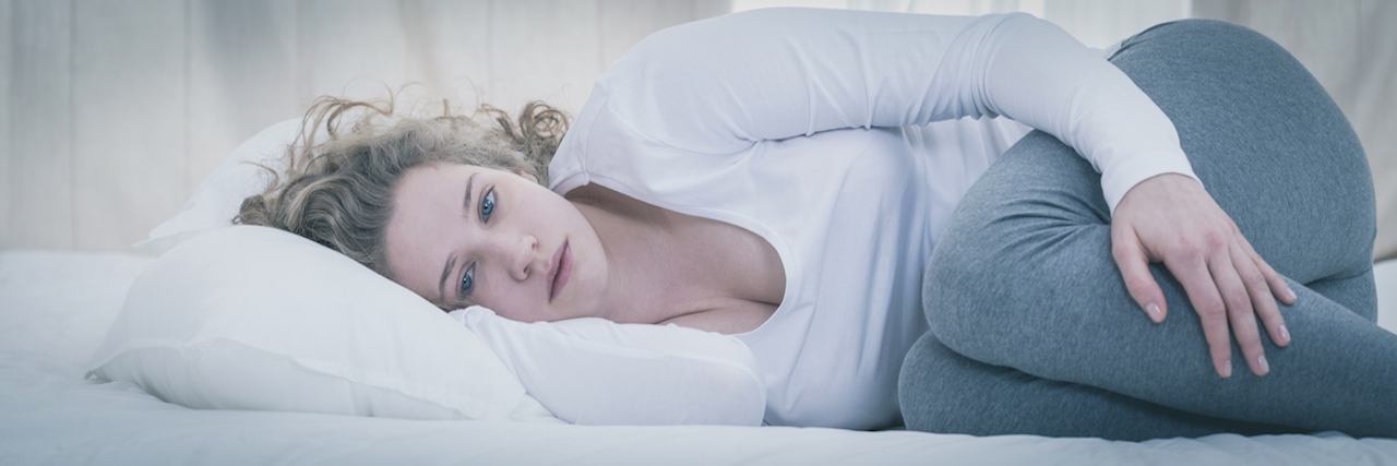 What a Day Is Like Stuck in Depression Young depressed woman lying alone in her bed