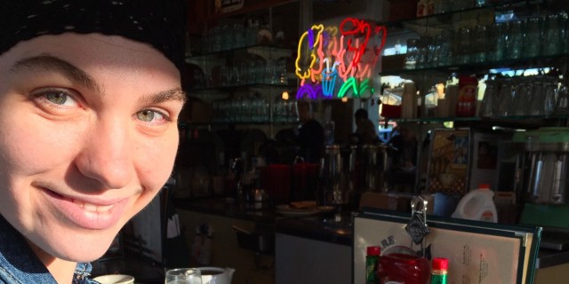 How Two Strangers Reacted to My Chronically Ill Daughter's 'Food Celebration' young woman sitting at the bar at a restaurant